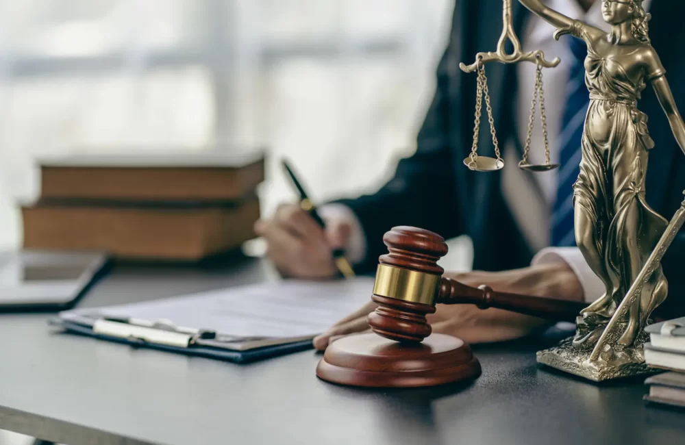 lawyer working at the desk Hammer and scales on lawyer's table for justice